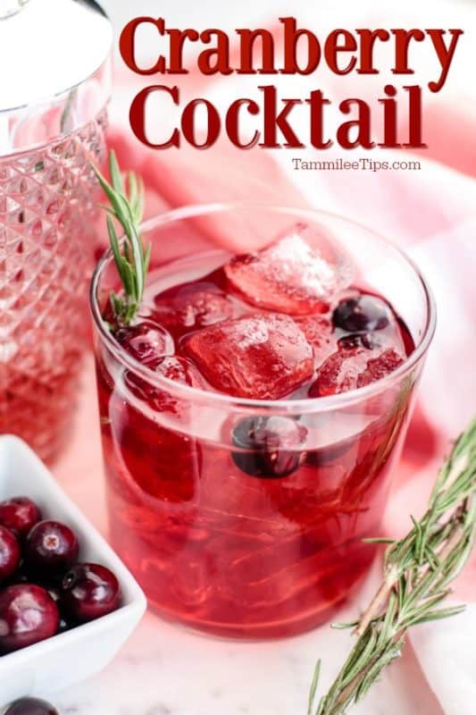 Cranberry Cocktail over a glass with red liquid and cranberries 