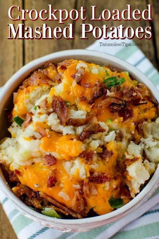 Crockpot Loaded Mashed Potatoes over a white bowl with potatoes, cheese, bacon, and onion