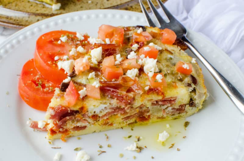 Greek frittata on a white plate with a fork