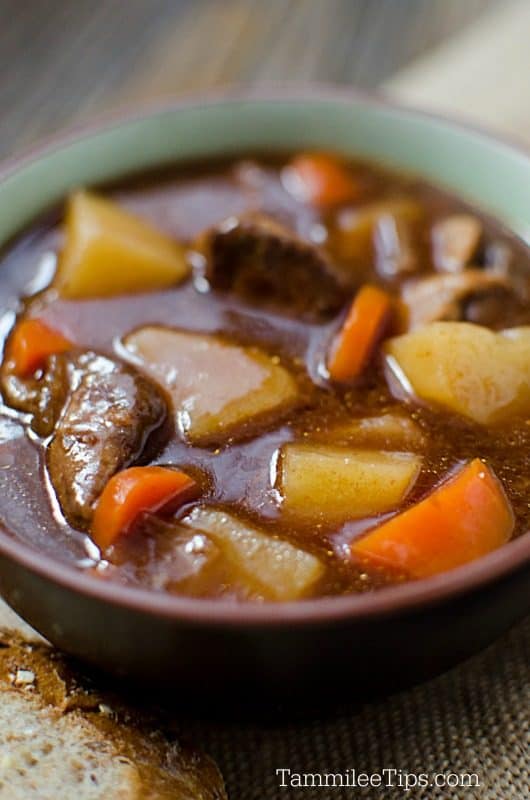 Guinness Beef Stew in a brown bowl with soda bread