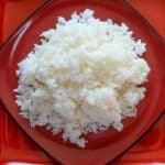 fluffy white rice on a red plate