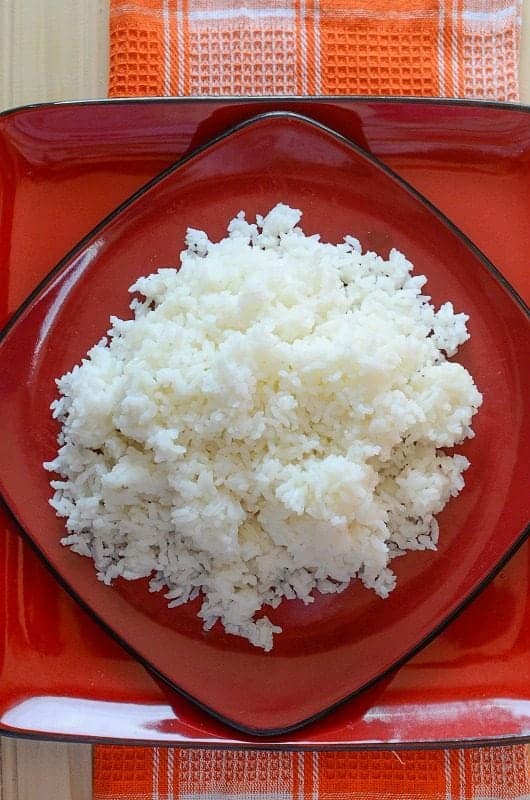 fluffy white rice on a red plate