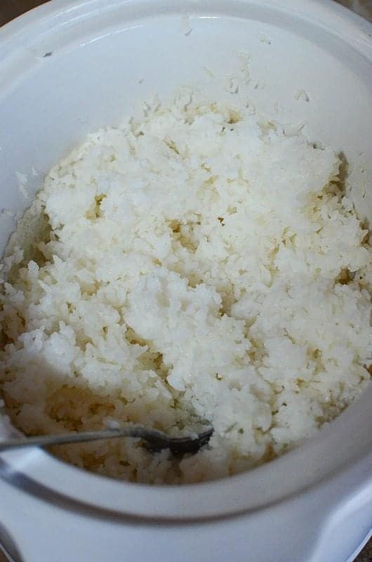 Rice in a slow cooker bowl with a fork