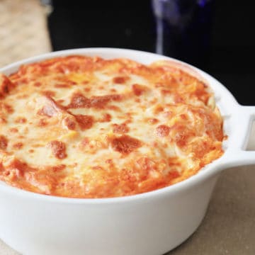 Baked ziti in a white casserole dish