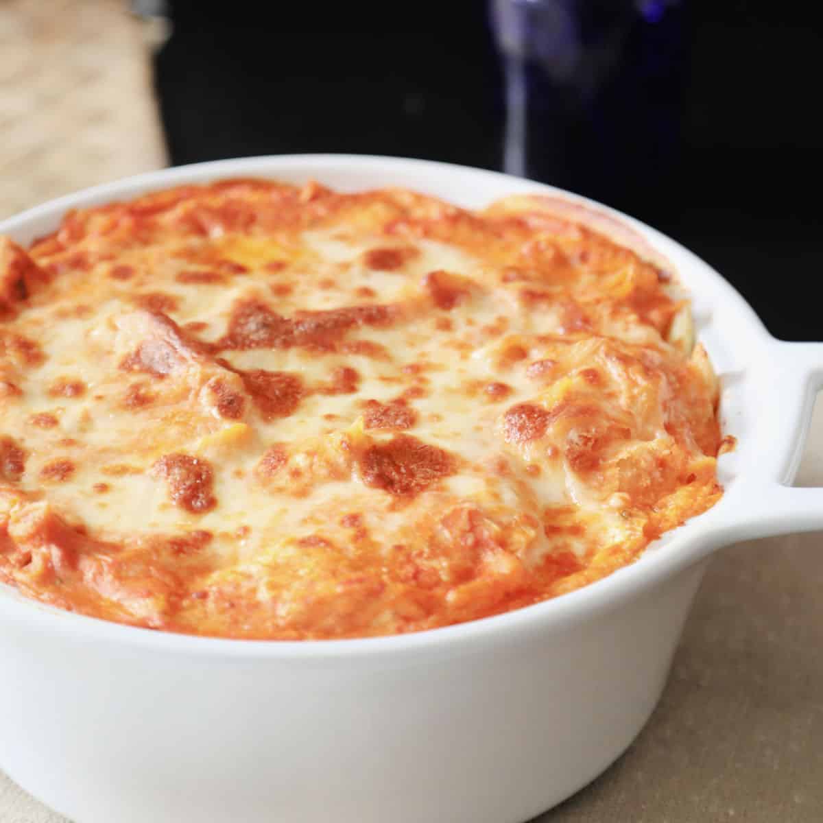 Baked ziti in a white casserole dish