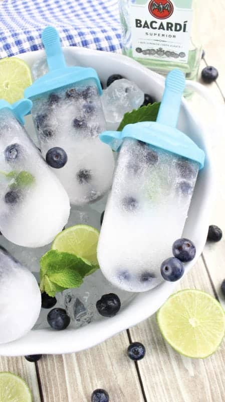Celebrate Summer with these boozy adult blueberry mojito popsicle recipe! Perfect for parties, barbecues, picnics or any day of the week.