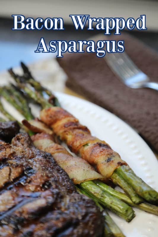 Bacon Wrapped Asparagus over a plate with asparagus and steak