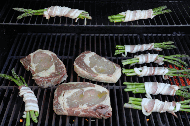 Bacon wrapped asparagus and steak on a grill