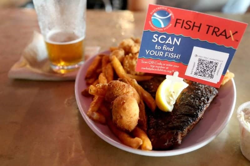 Fish Trax scan sign over a plate of seafood
