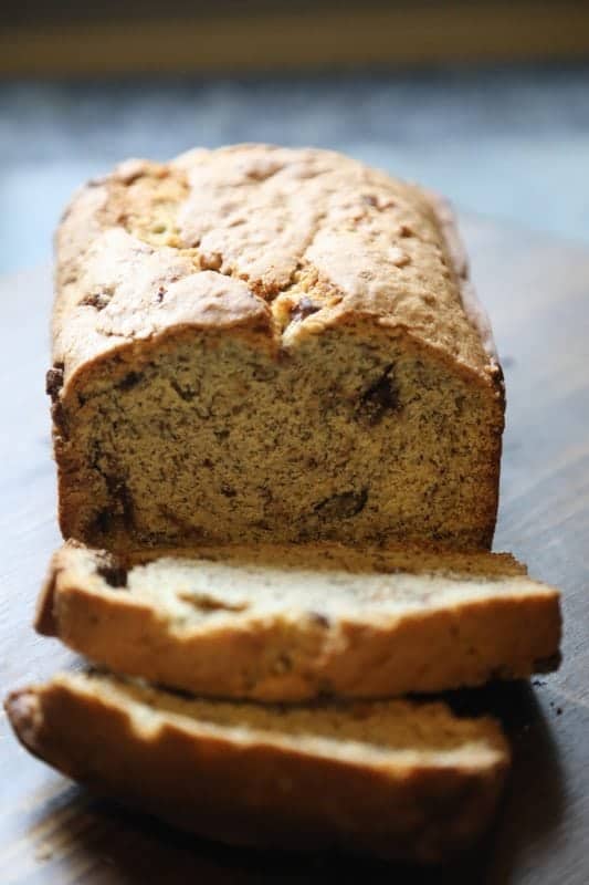 sliced chocolate chip banana bread on a cutting board 