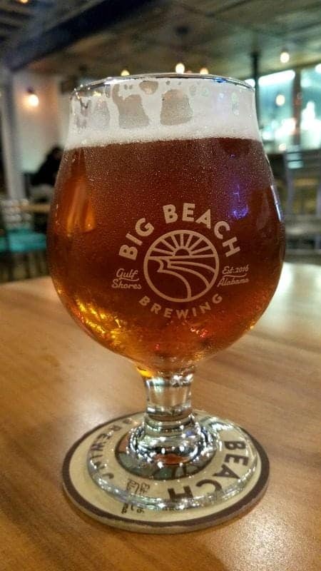 Big Beach Brewing cup on a wooden table