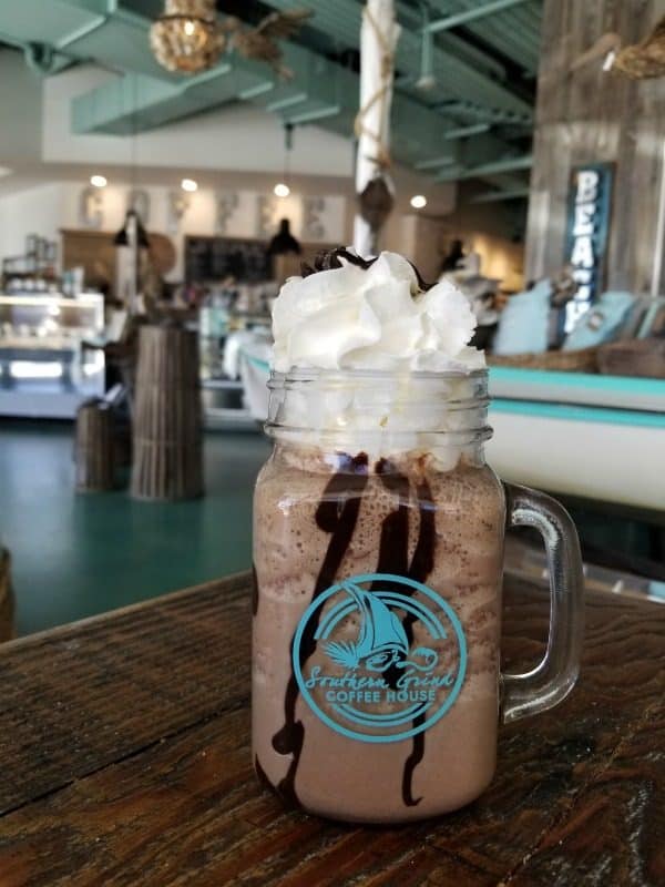 iced coffee covered in whipped cream and chocolate sauce in a Southern grind Coffee House mug