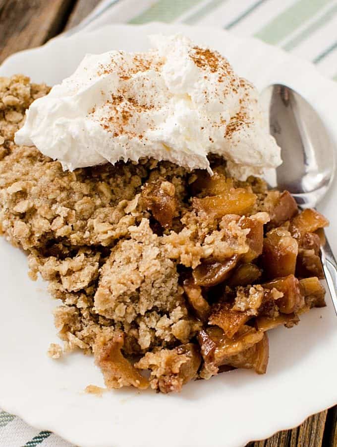 Easy crock pot slow cooker caramel apple crisp that is perfect for family dessert! A great fall comfort food!