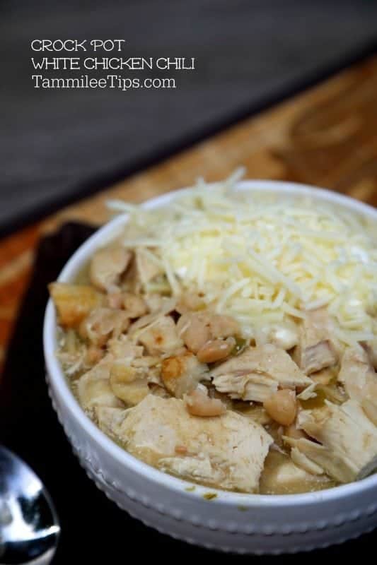 Crockpot White Chicken Chili over a white bowl with chicken, chili, and cheese 