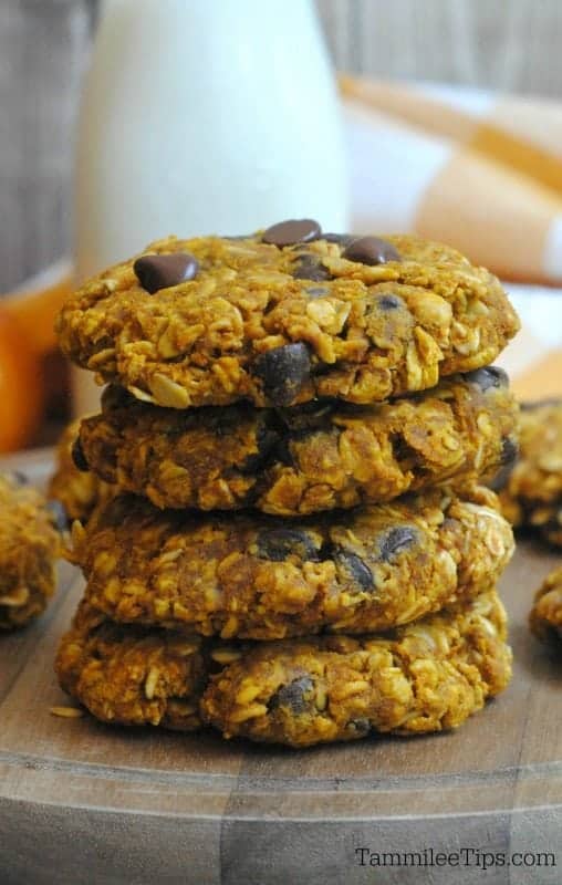 Stack of oatmeal chocolate chip cookies with a pumpkin and bottle of milk 