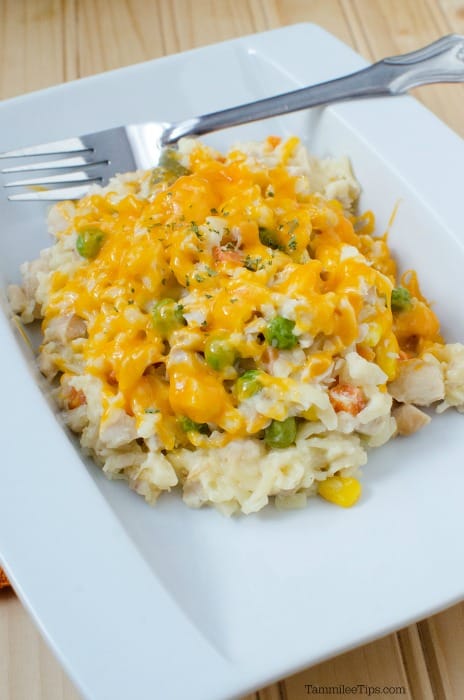 Chicken orzo casserole on a white plate with a fork