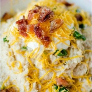 Crock Pot cheesy mashed cauliflower Recipe! This slow cooker recipe is good! Topped with bacon, cheese, green onions and more! #slowcooker #crockpot #recipe