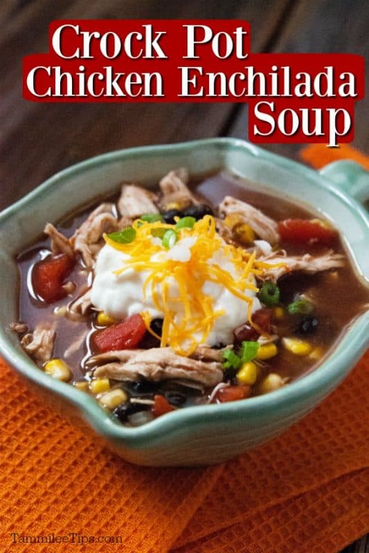Crockpot chicken enchilada soup over a bowl of soup garnished with sour cream and cheese