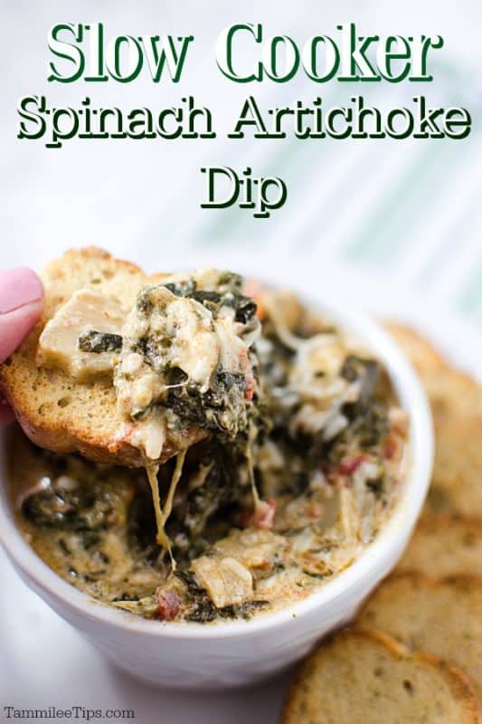 Slow Cooker Spinach Artichoke Dip over a white bowl with a piece of bread covered in cheesy dip