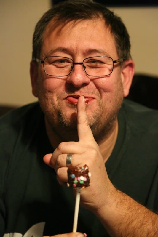 John holding a chocolate covered marshmallow