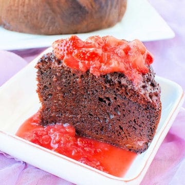 Crock Pot Chocolate Strawberry Cake on a white plate with strawberry sauce