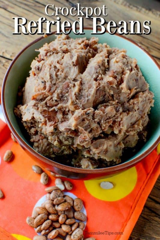 Crockpot refried beans over a bowl of beans 