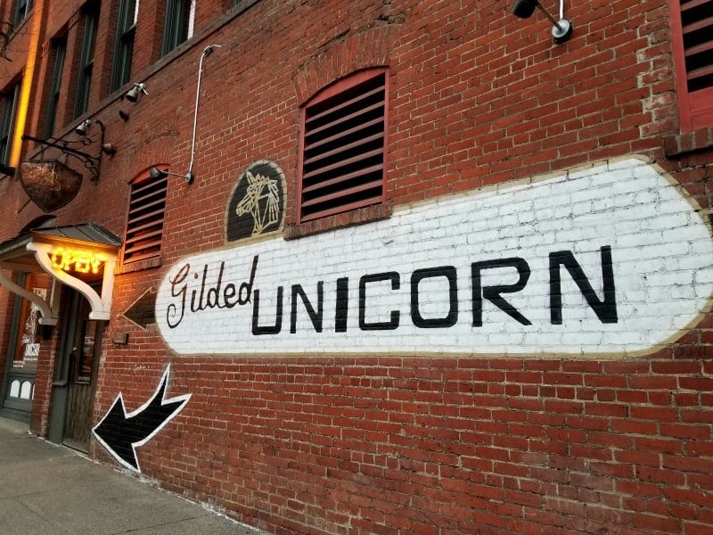 Gilded Unicorn painted on a brick wall