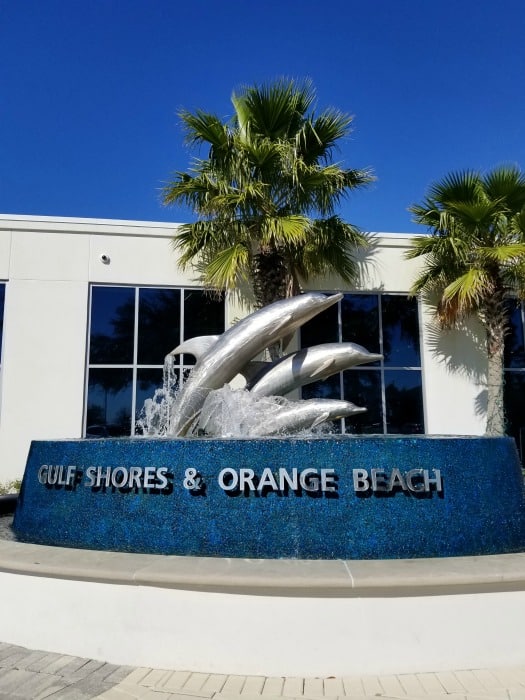 Gulf Shores Orange Beach dolphin fountain next to palm trees
