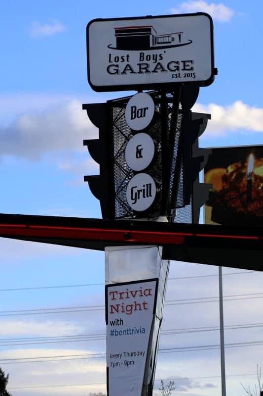 Lost Boys Garage bar and grill sign over trivia night sign