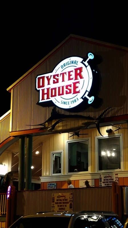 Original Oyster House sign lit above the restaurant