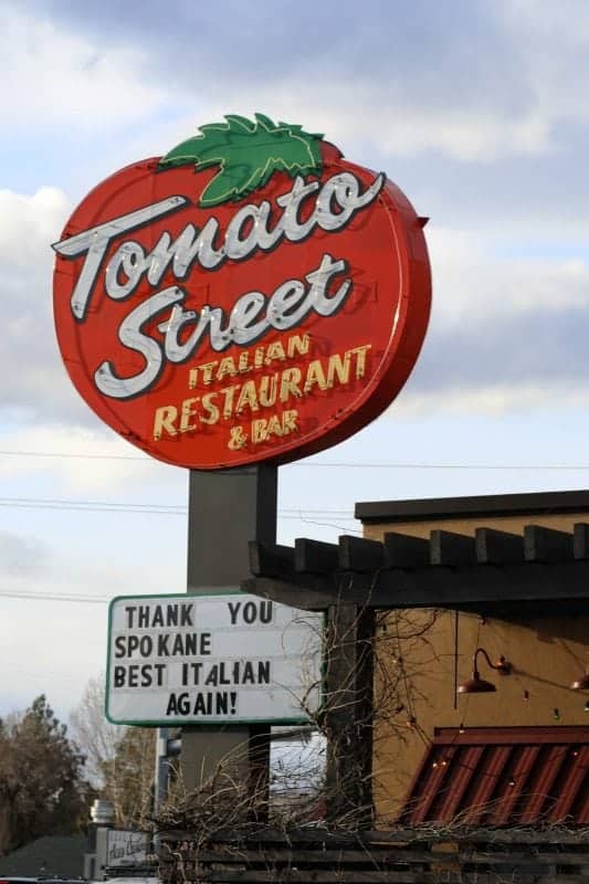 Tomato Street Italian Restaurant sign over a restaurant and sign with thank you spokane 