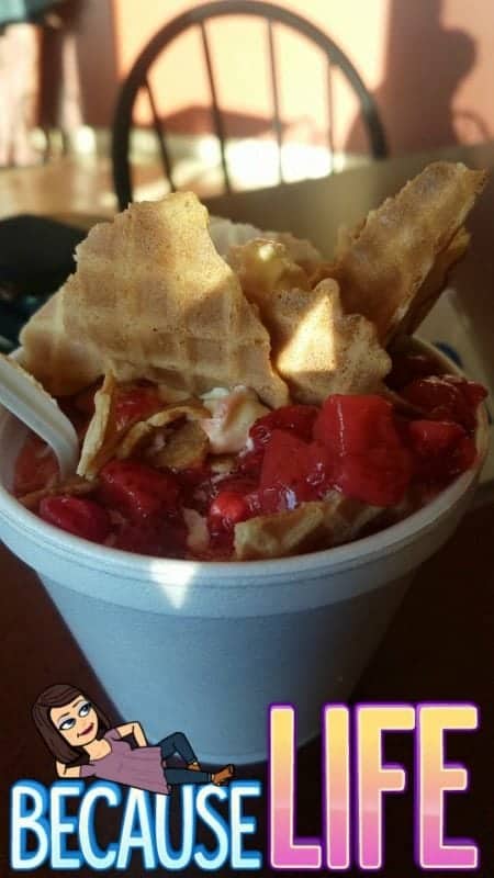 Froyo in a cup with waffle pieces and strawberries