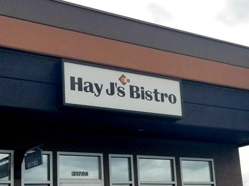 Hay Js bistro sign above windows