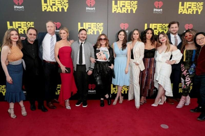 Life of the party cast Gillian Jacobs, Stephen Root, Matt Walsh, Julie Bowen, Ben Falcone, Executive Producer/Writer/Director, Melissa McCarthy, Executive Producer/Writer/Actor, Molly Gordon, Debby Ryan, Adria Arjona, Jessie Ennis, Luke Benward, Yani Simone, Jimmy O. Yang in front of a life of the party sign