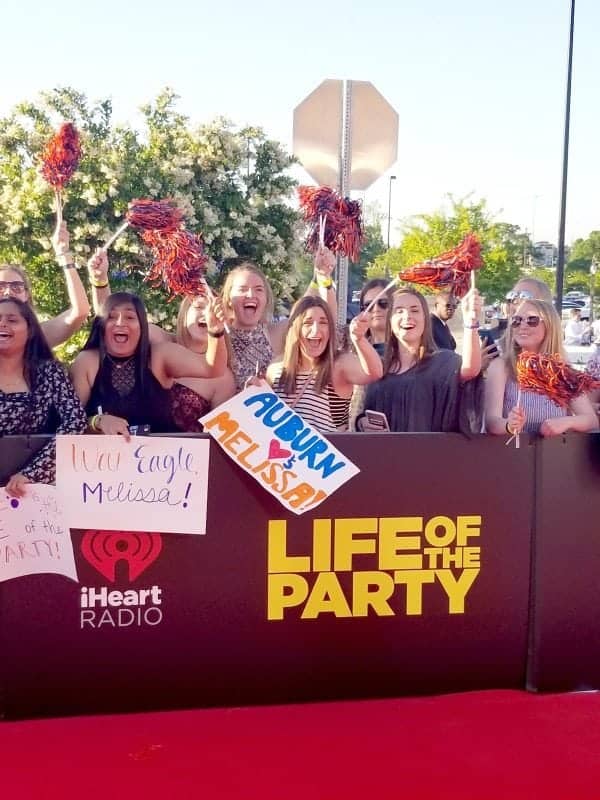 Crowd with pom poms next to a Life of the Party sign