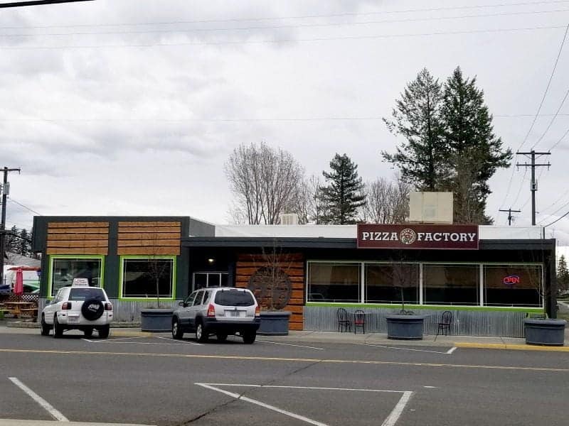 Exterior of Pizza Factory with cars parked out front