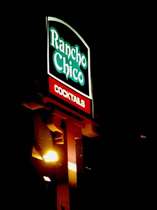 Rancho Chico sign lit up at night