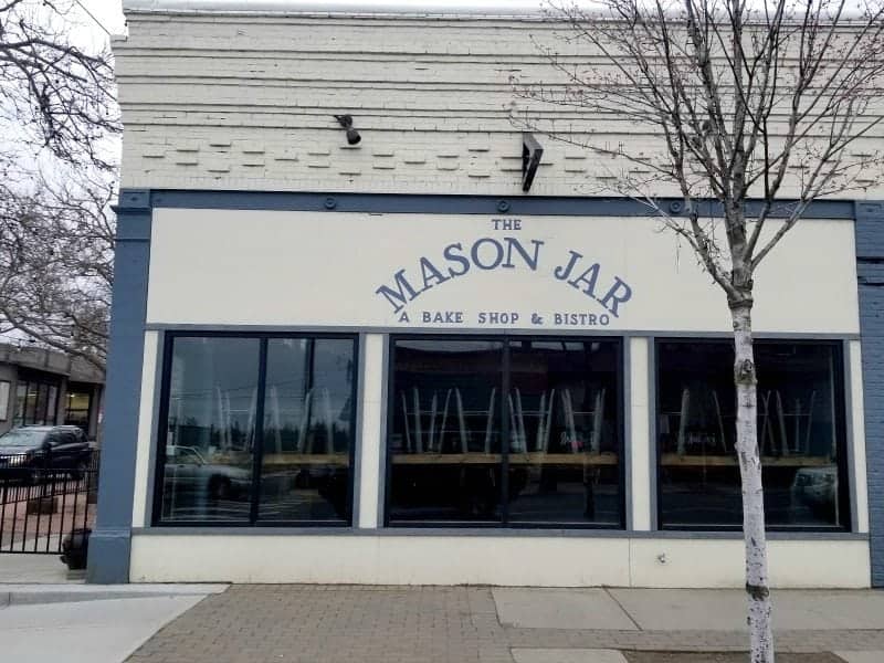 Exterior of the Mason Jar Bake Shop and Bistro with windows and trees outside