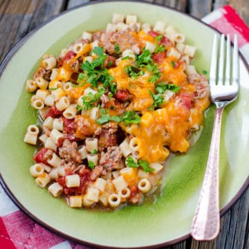 Cheeseburger Casserole on a green plate with a fork