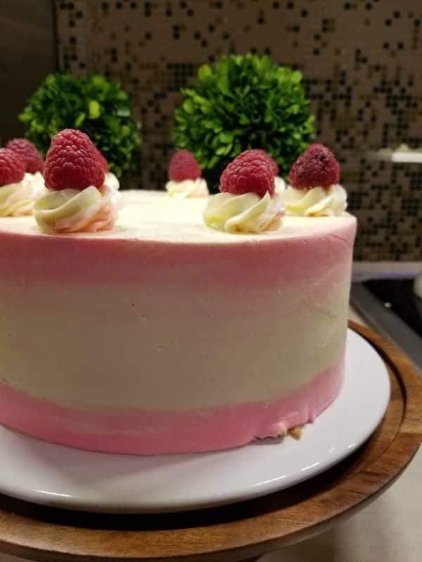 Raspberry cake with pink stripes on a cake platter