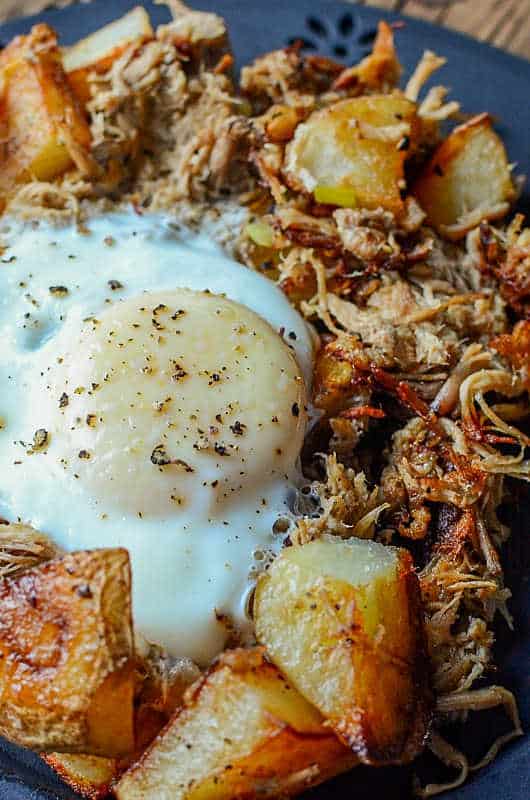 Pulled Pork Breakfast Hash on a blue plate with a fork