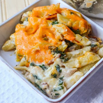 chicken pasta casserole with cheese in a white bowl