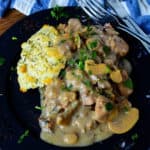 Crockpot Rosemary Pork on a blue plate with a fork and knife