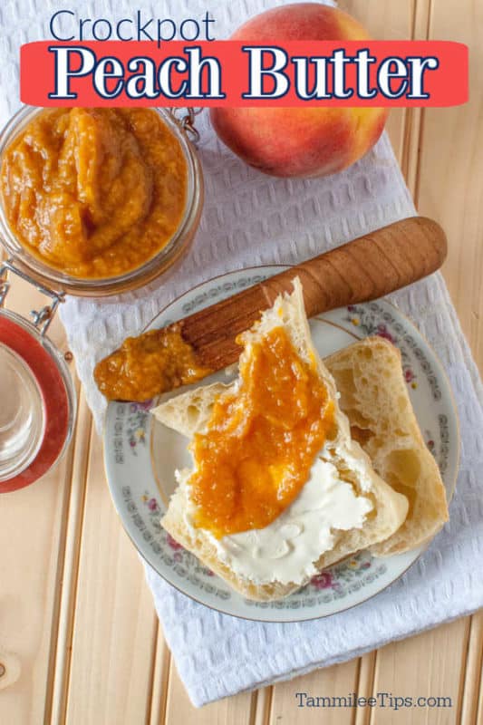 Crockpot Peach Butter over a white napkin with a wooden knife, muffin covered in peach butter, a fresh peach, and glass lidded container with peach butter in it. 
