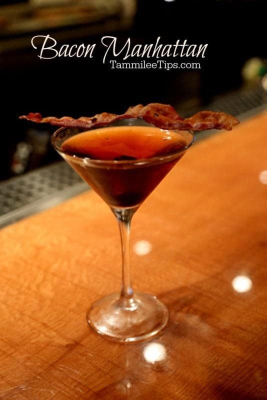 Bacon Manhattan text over a martini cocktail garnished with a strip of bacon