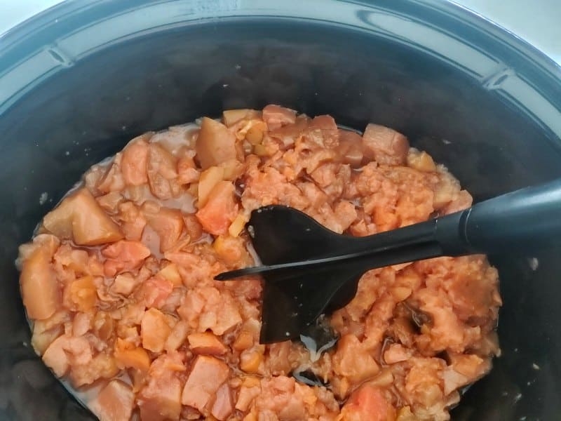 pears being mashed in a crockpot bowl