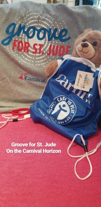 Groove for St. Jude shirt next to a bag and teddy bear