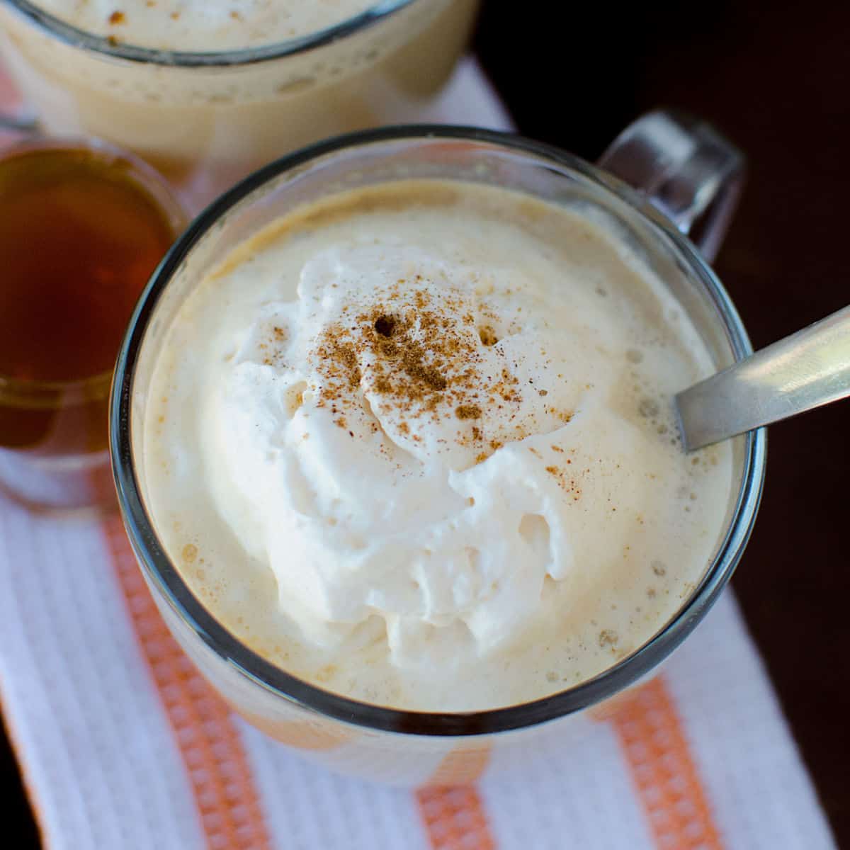 Crockpot Pumpkin Spice Latte in a glass mug with a silver spoon