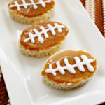 Salted Caramel Rice Krispies Football Treats on a white platter