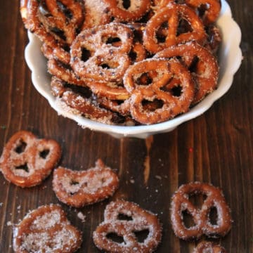 Cinnamon Sugar Pretzels in a white bowl and spread on a wood board